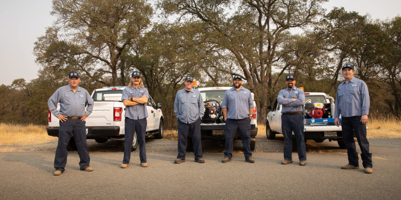 PMVCD Employees standing in front of PMVCD vehicles